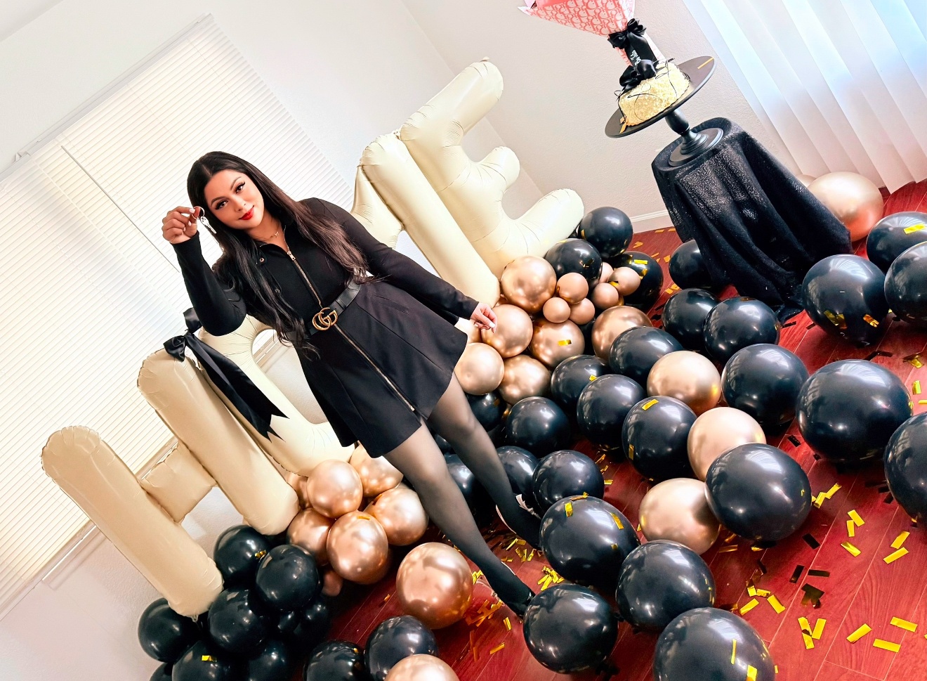 Taty Recinos celebrating a client's new home purchase with keys and balloons in Bakersfield