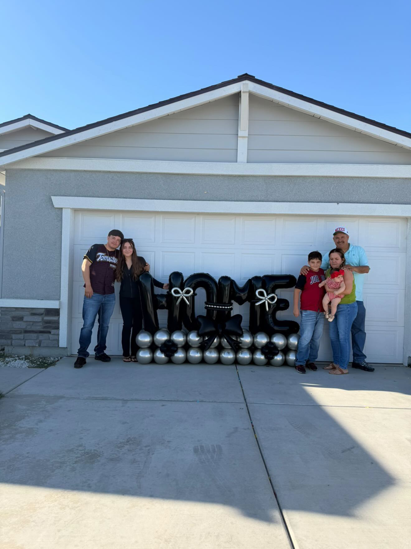 Family in front of their newly purchased Bakersfield home